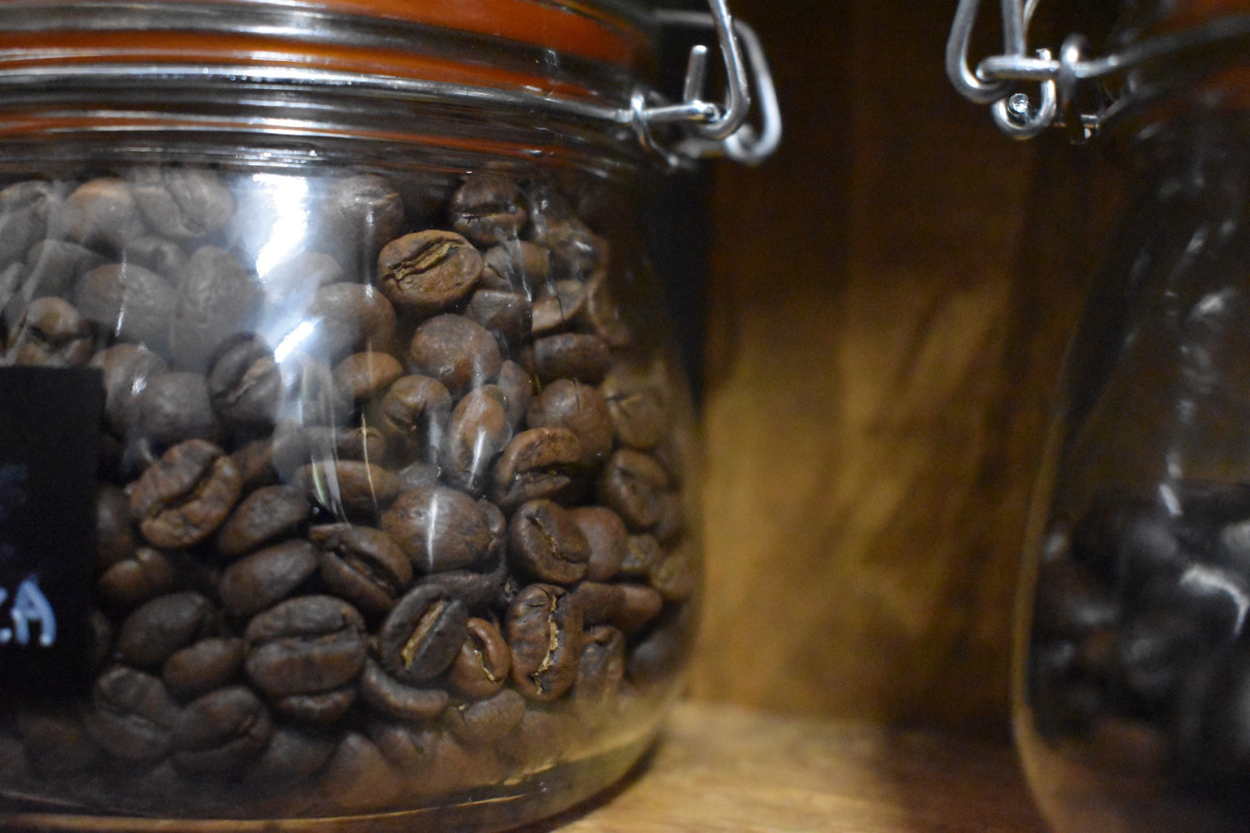 Close-up on a jar of coffee beans.